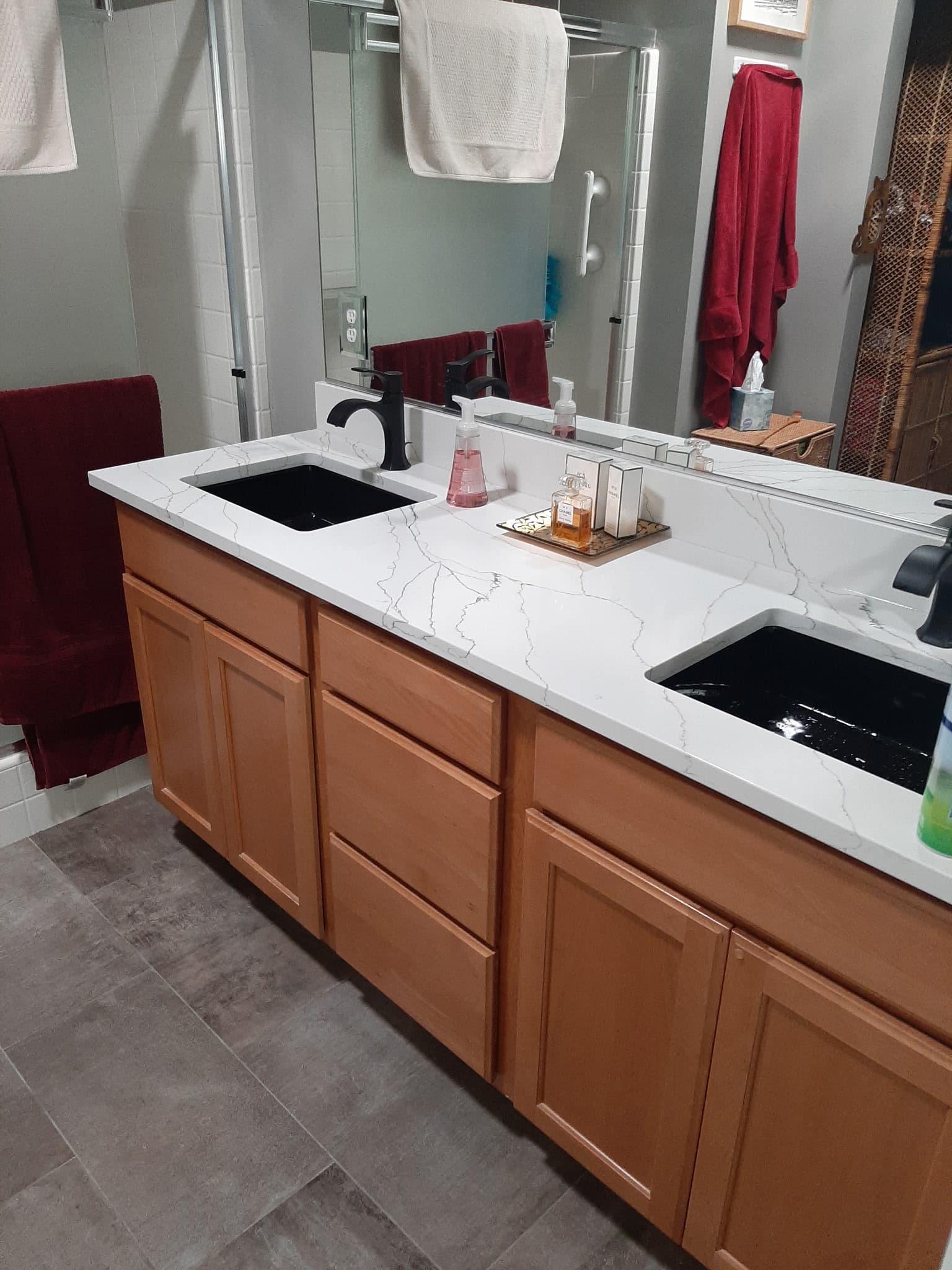 Double vanity with quartz countertop and oak cabinetry