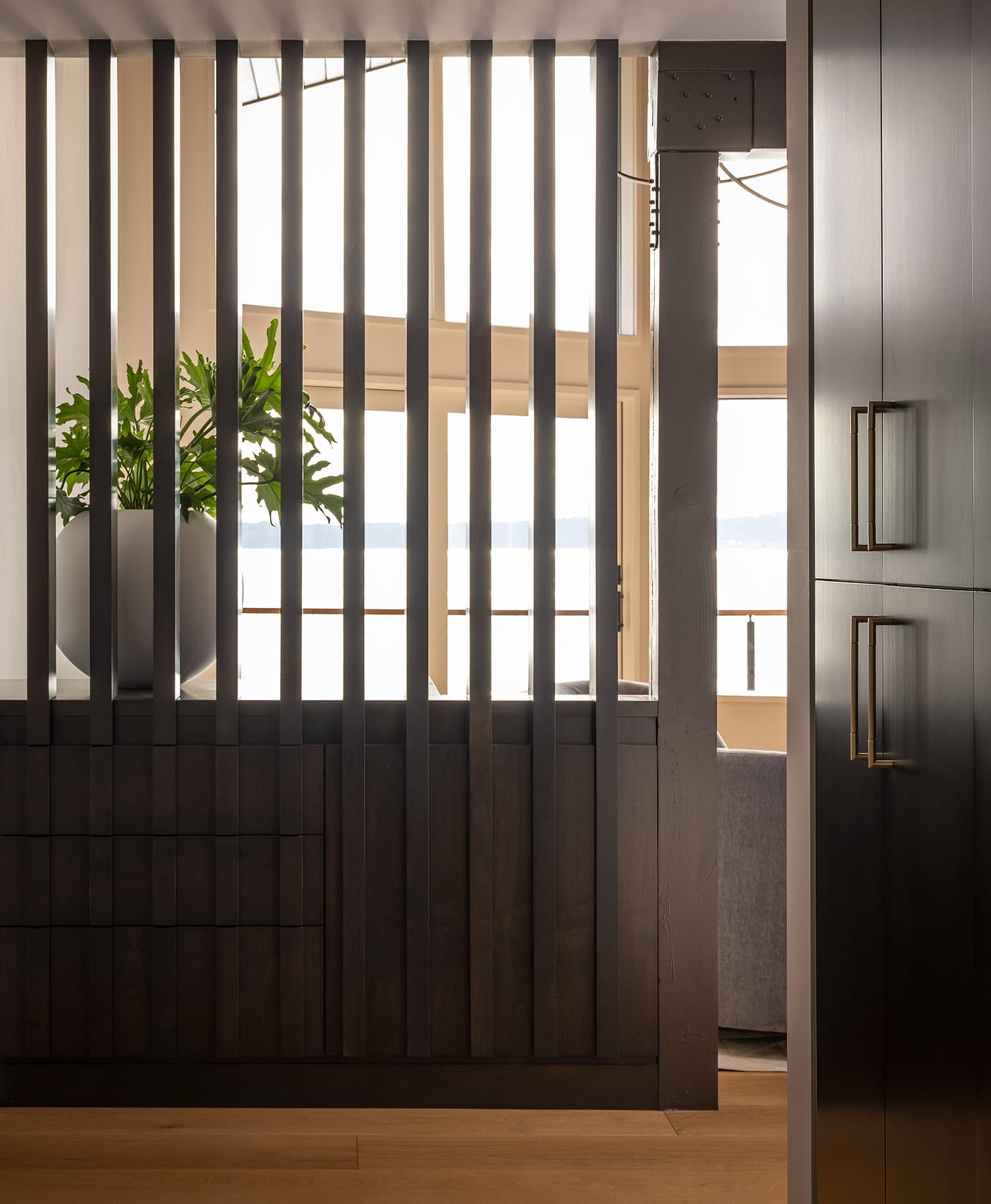 Custom vertical slat room divider with view through to living area