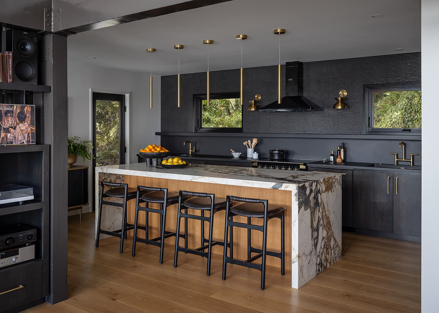 Kitchen with marble island, brass pendant lights, and bar seating